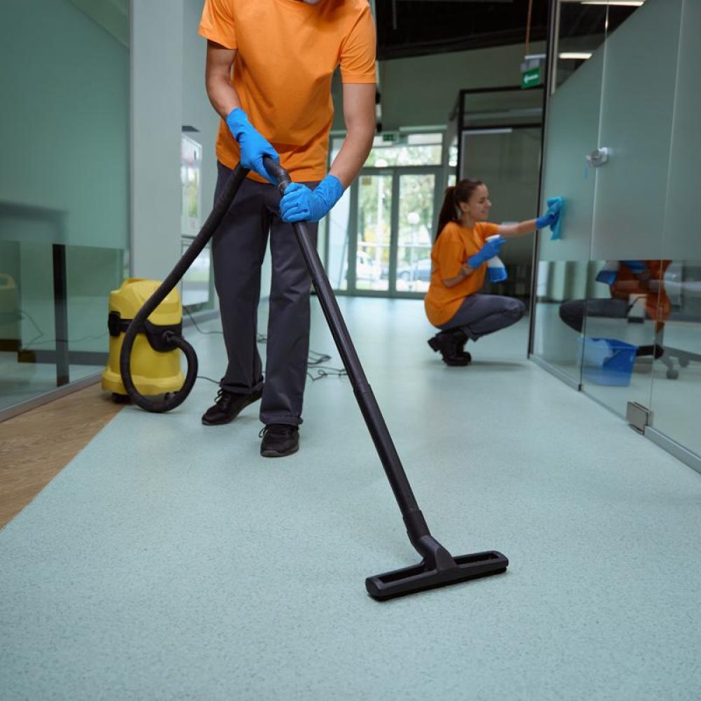 hard-working-man-in-uniform-tidying-the-floor-in-t-2023-11-27-05-21-56-utc